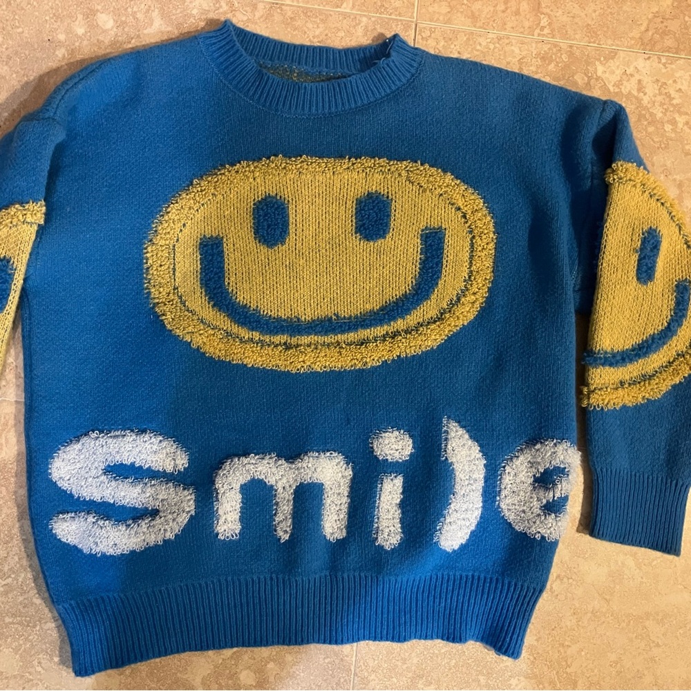 Women’s blue smiley face sweater medium